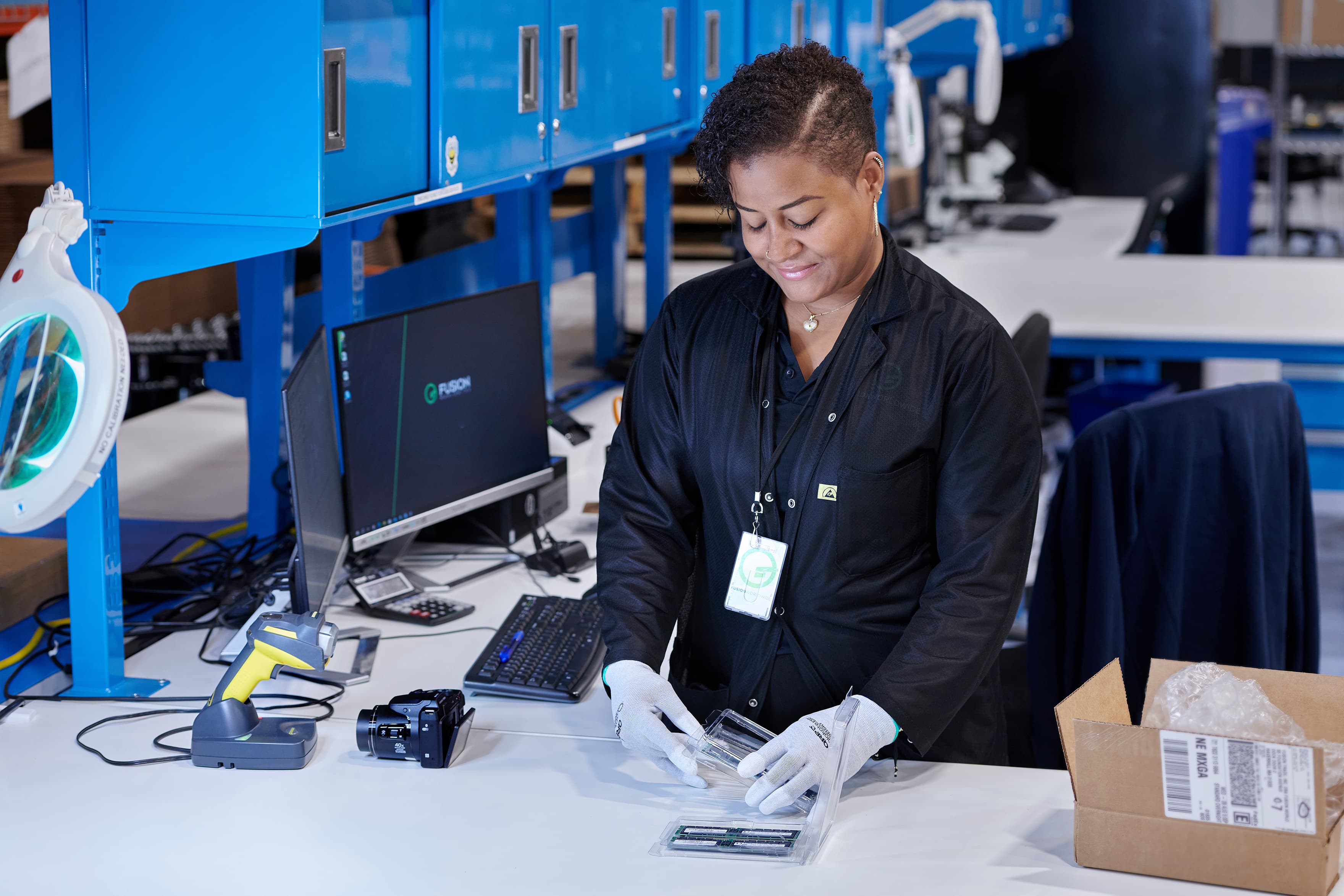 Quality control inspector examining electronic components at a work station