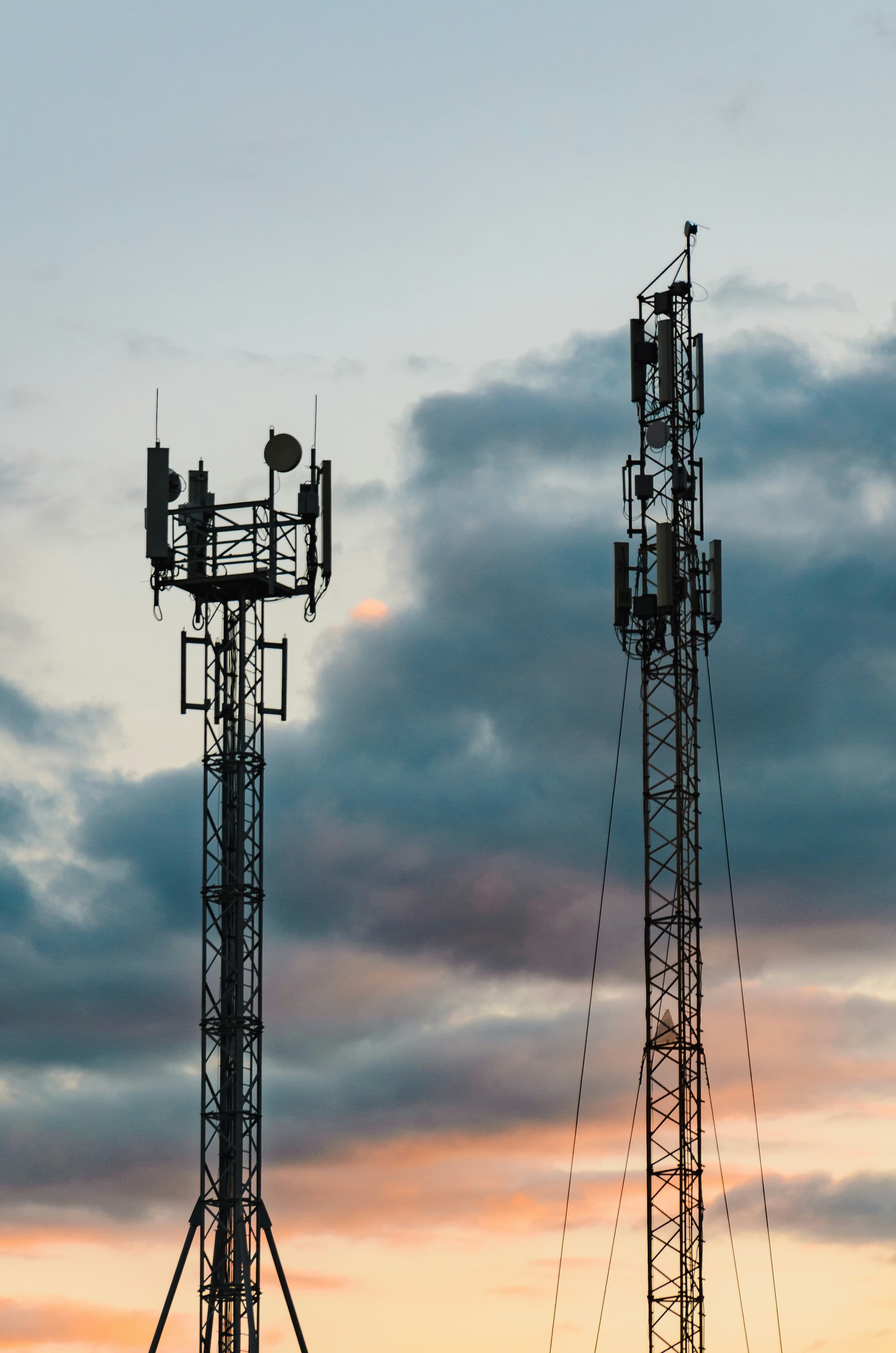 Two telecom towers at sunset