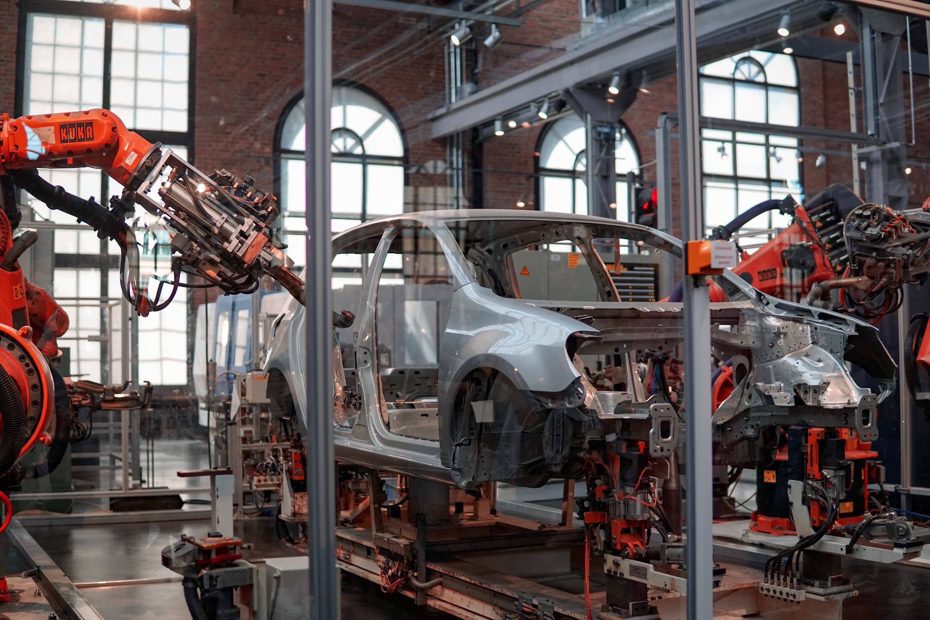 Two automated robots assembling a car in a factory