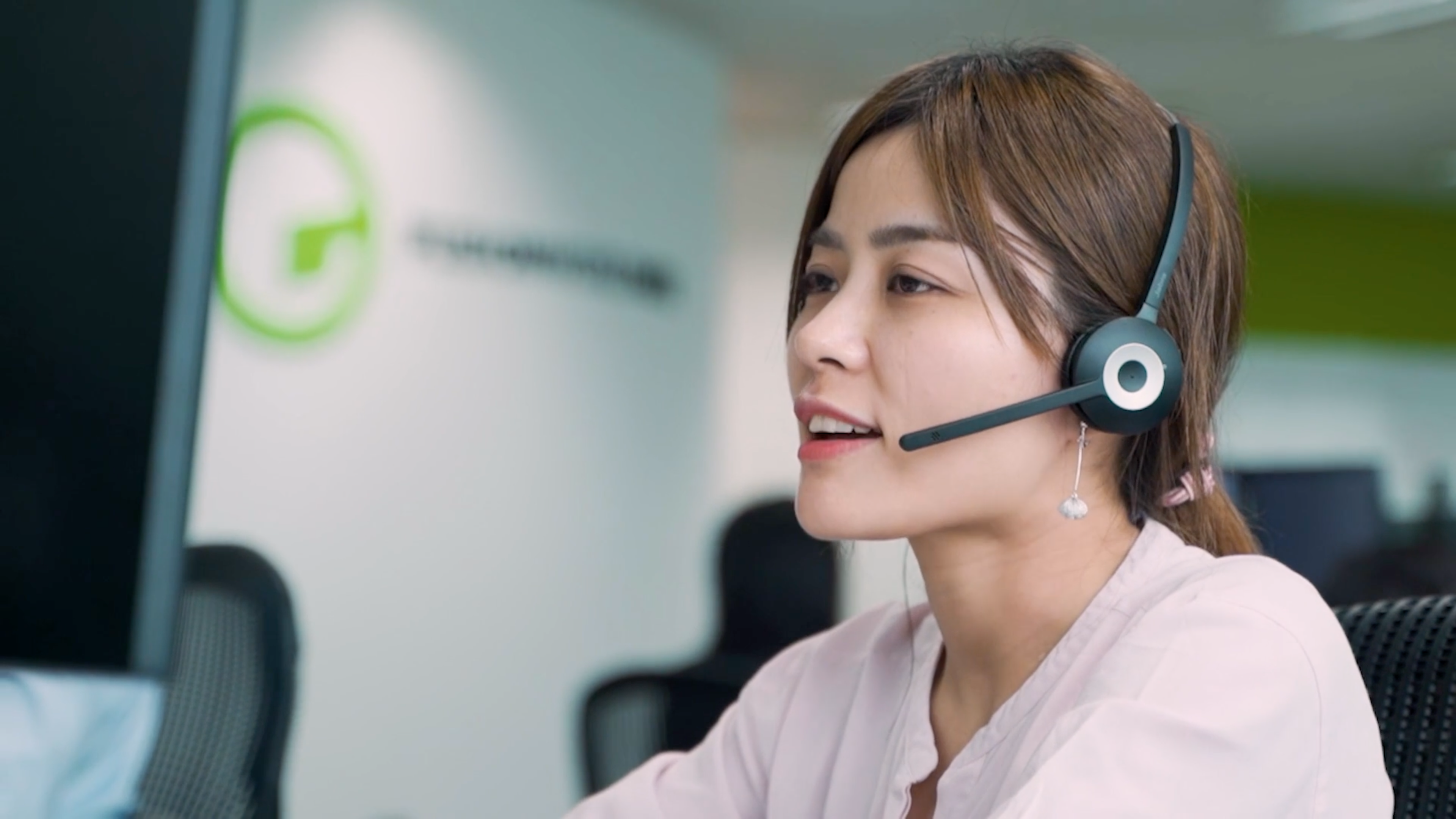 Fusion Worldwide employee taking calls on a headset