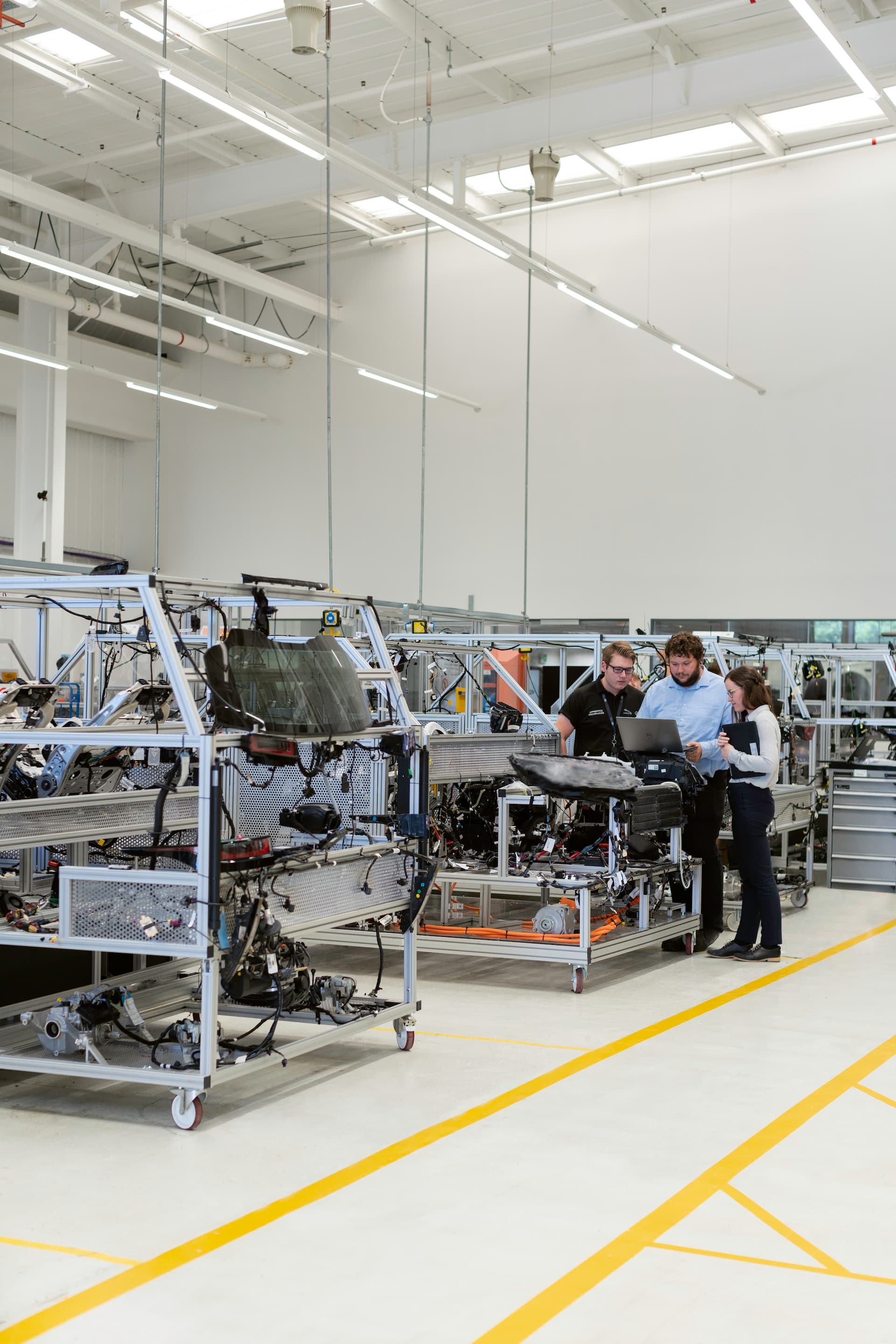 Group of engineers standing around a computer in the Fusion office